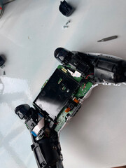 Cleaning and repairing game controller joystick, gaming maintenance and electronics repair concept