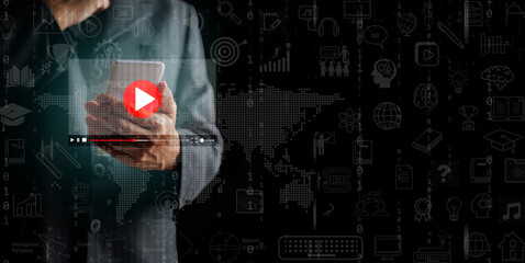 Man using smartphone with a video player interface with educational icon and binary code in background. Online global education access, mobile e-learning technology, digital training, video courses.