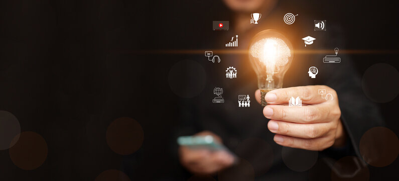 Man with smartphone holding glowing lightbulb with brain surrounded by educational icons. Education, self improvement, knowledge, innovation, digital learning tools, skill development, online training