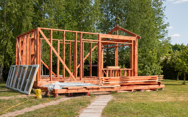 Wooden structure of a house with a roof. Wooden rafters. new building of a future bathhouse