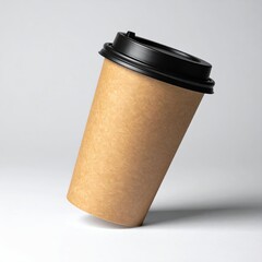 Eco-friendly takeaway coffee cup with black lid tilted on white background