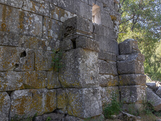 Ruins of the city of Termessos. An ancient city located high in the mountains of Turkey. The walls of the buildings in the ancient city are made of huge stone blocks. Masonry of ancient buildings.