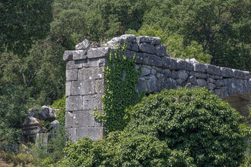 Ruins of the city of Termessos. An ancient city located high in the mountains of Turkey. The walls of the buildings in the ancient city are made of huge stone blocks. Masonry of ancient buildings.