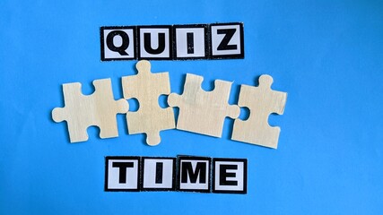 “QUIZ TIME” with puzzle pieces on blue background symbolizes challenge, learning, and interactive thinking activity.