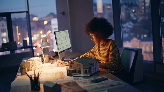 Structural engineer working late browsing architectural plan at computer closeup