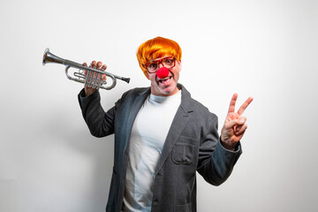 Clown man playing trumpet making peace sign