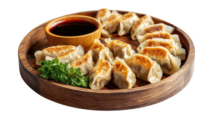 A plate of dumplings with a sauce on the side, isolated on a transparent background
