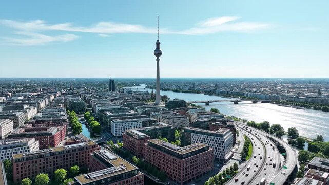 Aerial view of berlin cityscape featuring the fernsehturm and spree river on a sunny day, 4k