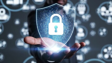 Businessman holding digital shield with padlock icon for cybersecurity and data protection concept, 4k - Powered by Adobe