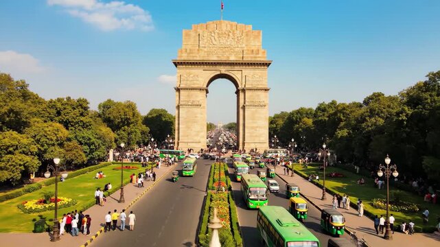 India gate in new delhi with traffic and surrounding park on a sunny day, 4k