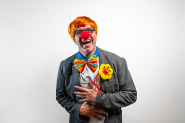 Happy clown laughing wearing red nose and rainbow bow tie