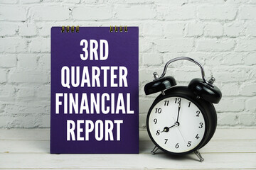 1st Quarter Financial Report text with alarm clock on white brick wall and wooden background