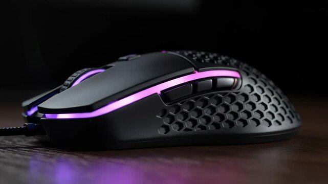 Close Up of Modern Gaming Mouse With Rgb Lighting on Wood Surface