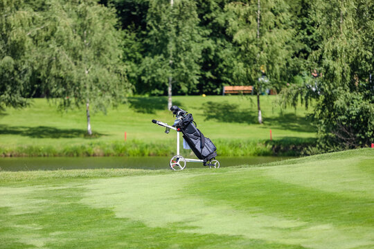 golf bag with clubs on a course with a lake in the background