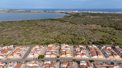 Aerial view of coastal housing near nature reserve and saltwater lagoon