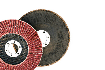 Close-up of two abrasive flap discs on white background, one front and one back view, used for metal grinding and surface finishing tasks