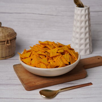 Crunchy cheese-flavored corn chips coated with a rich, savory cheese seasoning. These bite-sized snacks are popular for their bold taste and crisp texture, making them ideal for snack bowls, party foo