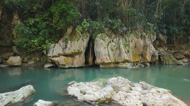 Pum Pum Rock at Bag Walk Gorge, Jamaica, where crystal clear river water moves through dramatic rock formations in a peaceful tropical setting
