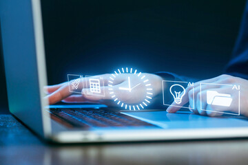 Hands typing on computer keyboard with holographic icons in a dark setting at night