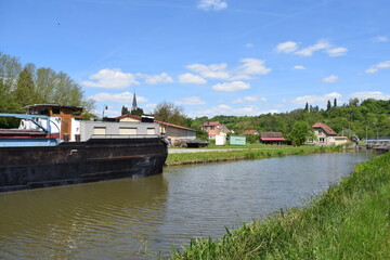 big boat on the Sarre channel with the village Wittring in background