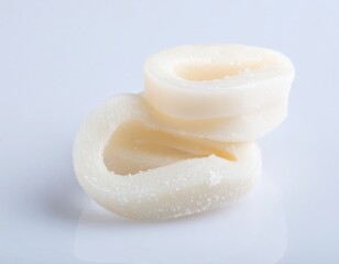 Fresh Frozen Squid Rings Stacked on White Surface