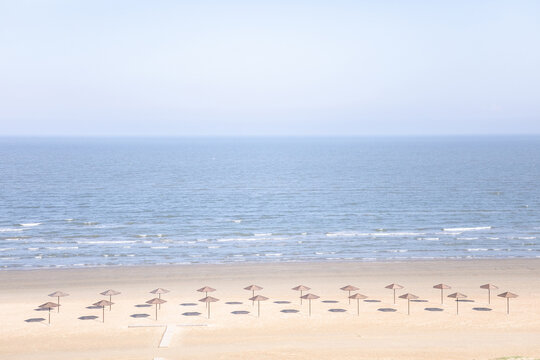 Minimalist Beach with Sun Umbrellas on the Caspian Sea Coast