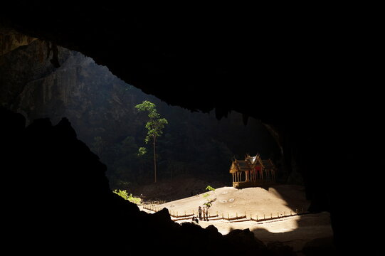 a golden temple inside a cave, illuminated by the sun.