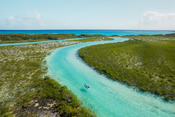 Aerial view of small motorboat in winding channel