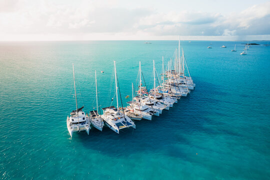 Aerial view of catamarans rafted together in tropical water