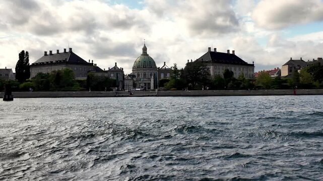Panoramic Harbor Boat View of Amalienborg Royal Palace and the Iconic Marble Church Dome in Sunny Copenhagen, Denmark.
