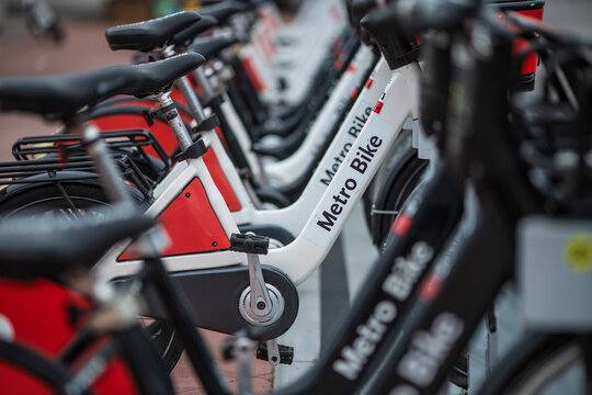 LOS ANGELES, CA - May 6, 2025: Row of Metro Bike share bicycles waiting for customers riders on city street. Closeup view.