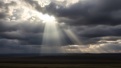 breakthrough. A single beam of sunlight breaking through dark clouds onto a landscape. travel magazines, destination branding, designed for outdoor magazines and nature guides.