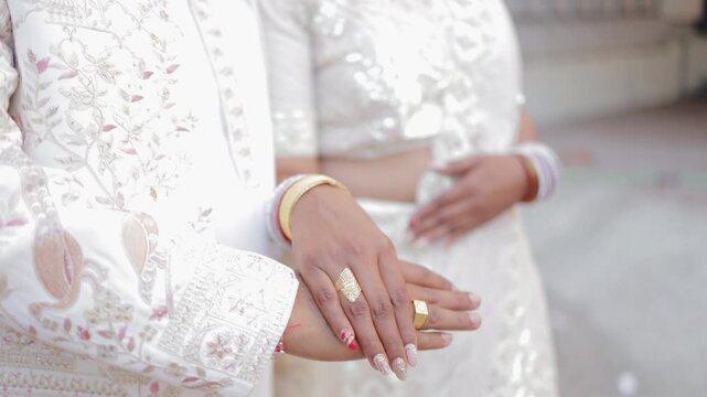 Joyous moment from an Indian ring ceremony where the bride and groom exchange rings as part of their engagement celebration