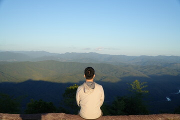 Man Sitting and Enjoying Mountain Landscape at Scenic Viewpoint