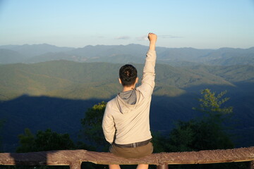 Man Sitting and Enjoying Mountain Landscape at Scenic Viewpoint