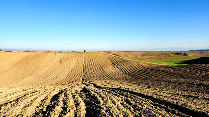 Plowed crop fields prepared for winter wheat sowing under a clear sky in the Mediterranean region