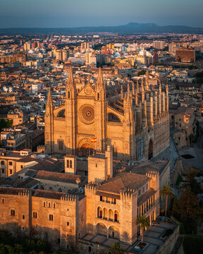 Mallorca, Spain - Aerial view of the famous Catedral-Basilica de Santa Maria de Mallorca at sunset with skyline view of Palma de Majorca, the capital city of the island. Blue sky