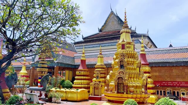 SIEMREAP, CAMBODIA - October 6, 2025: The interior of Wat Preah Prom Rath Temple. A Buddhist temple with statues of cows. A decorative structure made of gold. The main spiritual center of Siemreap. 4К