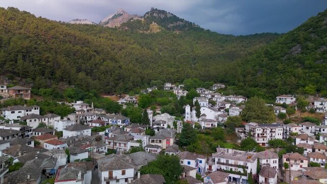 Tranquil morning aerial drone view over the traditional Greek mountain village of Panagia and the forested slopes of Mount Ipsarion on Thasos Island.
