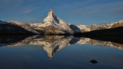 Snow capped Matterhorn mirroring in Lake Stellisee, Switzerland.