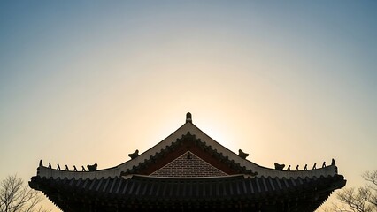 Fototapeta premium Traditional roof silhouetted against sunset