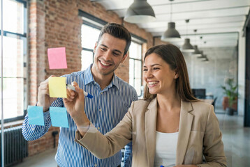 Colleagues brainstorming with sticky notes