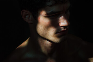 Obraz premium photography portrait of a handsome young man heavily shadowed