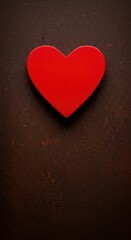 Obraz premium A vibrant red heart shape prominently displayed and completely isolated on a rustic, deeply textured brown background, symbolizing passion and love concept ,object ,celebration ,shape