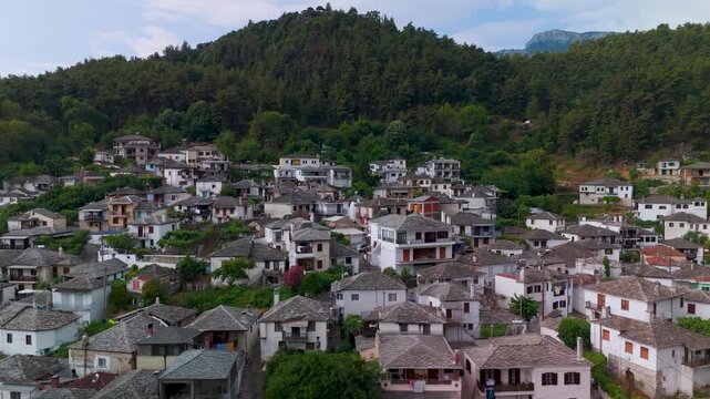 Picturesque aerial drone orbit around the traditional Panagia mountain village, showcasing hillside architecture and Mount Ipsarion, Thasos, Greece.