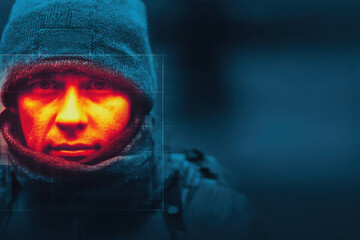 Obraz premium Thermal camera image shows person face with vivid heat map effect highlighting temperature differences in cold weather, creating striking and intense visual impression