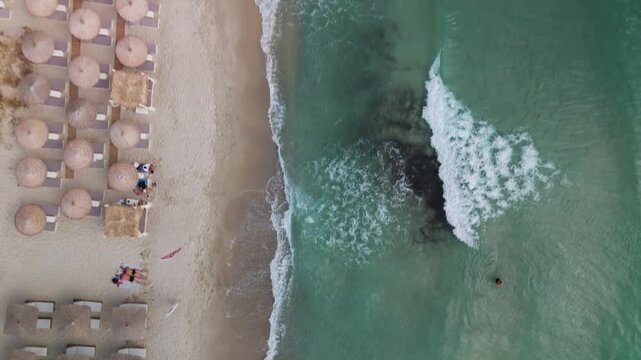 Vertical Top-Down Aerial Drone View Directly Over Golden Beach, Thasos, Greece, Highlighting the Golden Sand and Clear Turquoise Water of the Aegean Sea Bay.