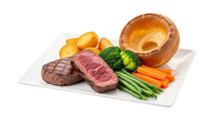Delicious steak dinner with roasted potatoes, fresh vegetables, and a golden yorkshire pudding isolated on transparent background