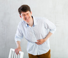Man experiencing acute abdominal pain