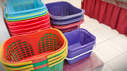 Colorful Plastic Shopping Baskets Stacked High, Home Organization and Storage Ideas With Plastic...